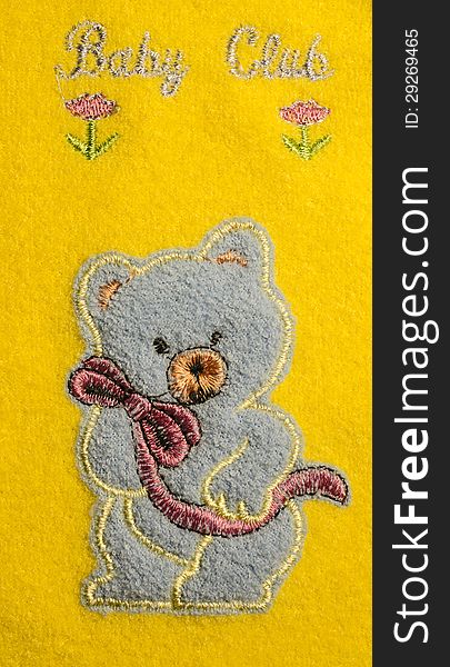 Blue Bear on yellow material with flowers. Blue Bear on yellow material with flowers