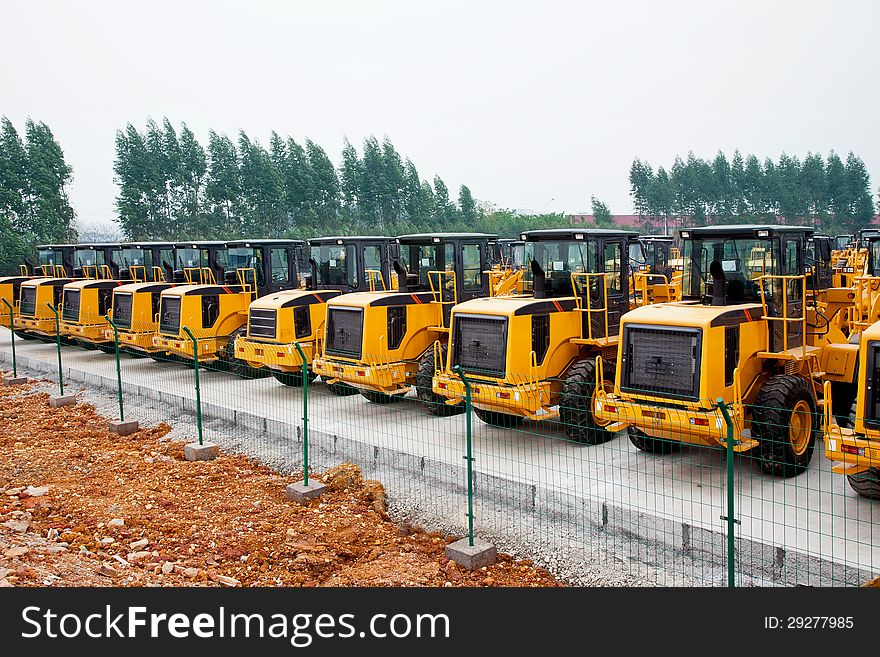 Open space neatly parked wheel loaders