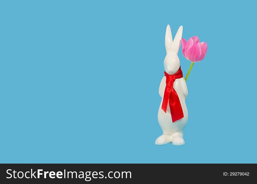 A rabbit with a tulip waiting for Easter. A rabbit with a tulip waiting for Easter.
