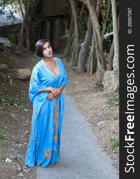 Girl in blue indian dress over dark alley