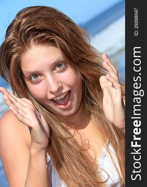 Closeup of a surprised young woman on the beach. Closeup of a surprised young woman on the beach