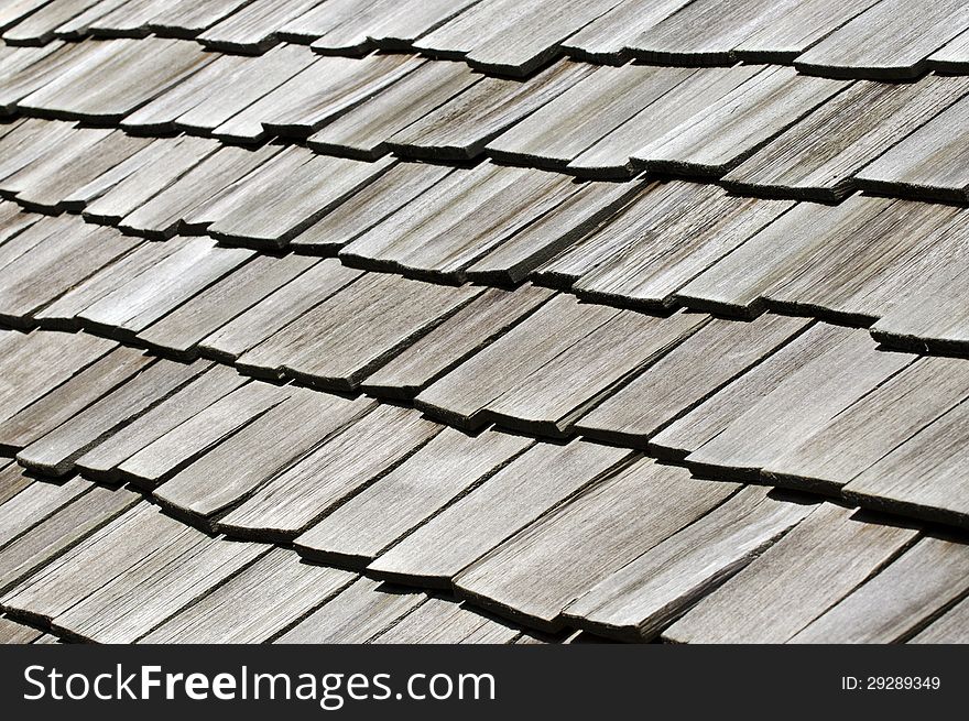 Raw of old black wooden tiles on an old house roof