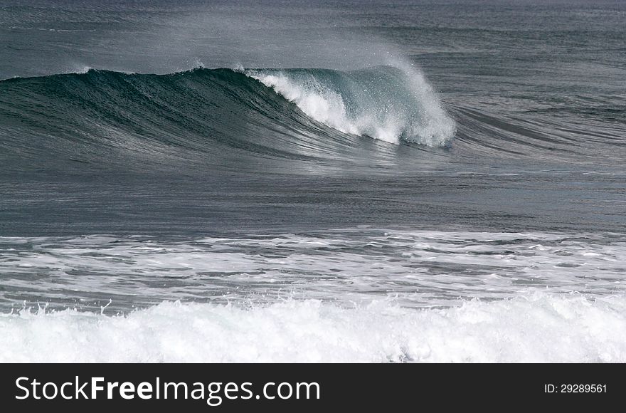 Windblown Foamy Surf Waves At Seashore. Windblown Foamy Surf Waves At Seashore