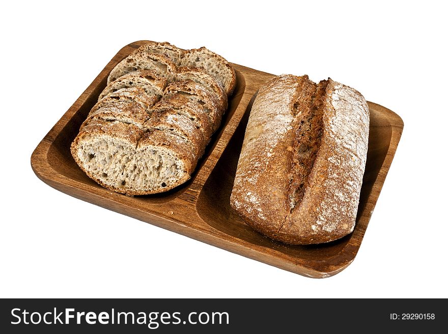 Sliced rye integral bread on wooden plate isolated on white background. Sliced rye integral bread on wooden plate isolated on white background