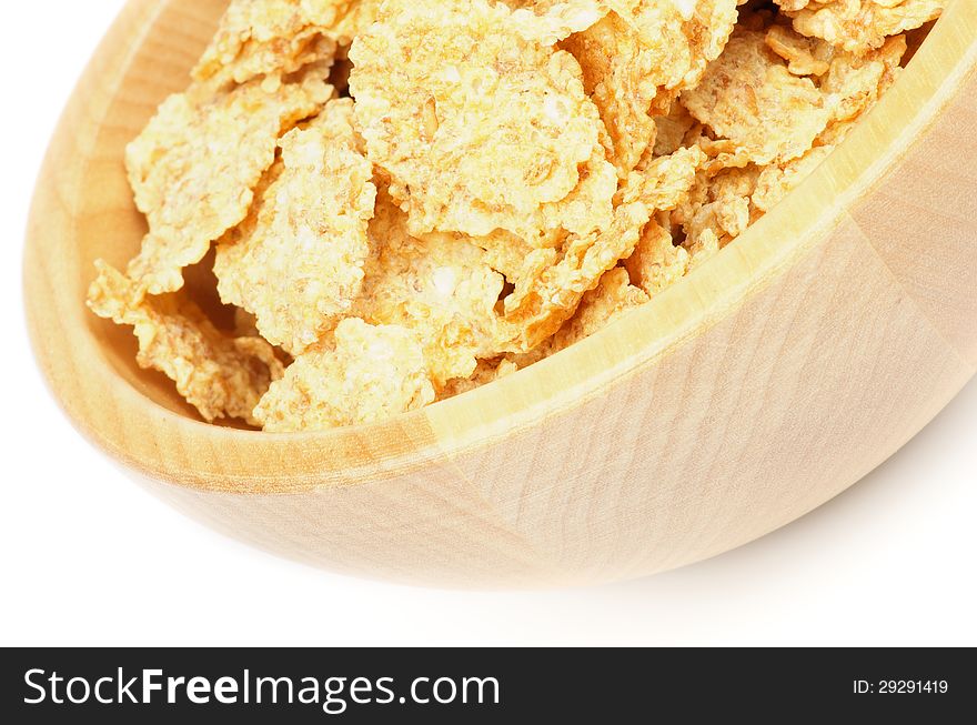 Flakes Breakfast Cereal in Wood Bowl closeup on white background