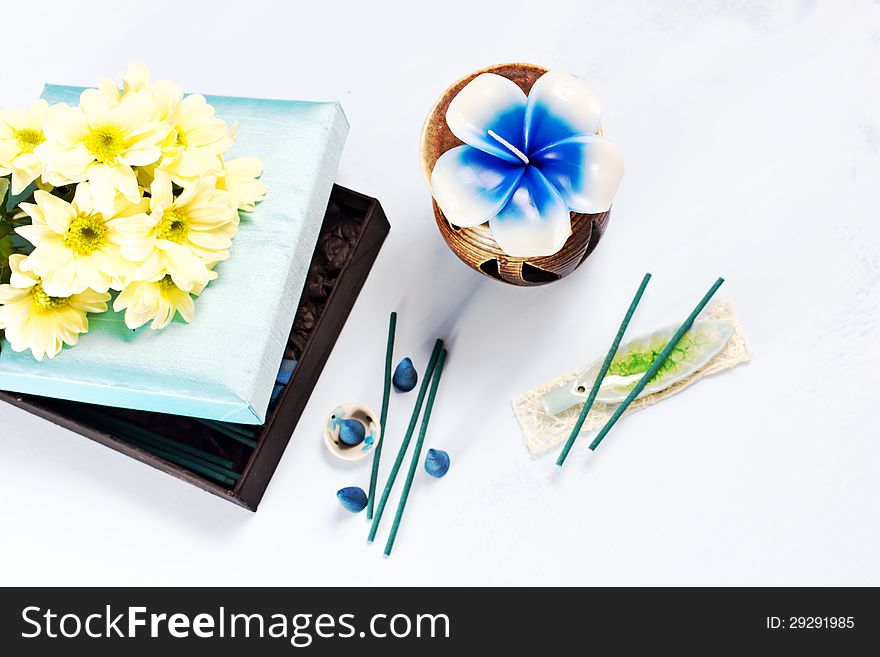 Aromatherapy set with flower candle and incense, selective focus