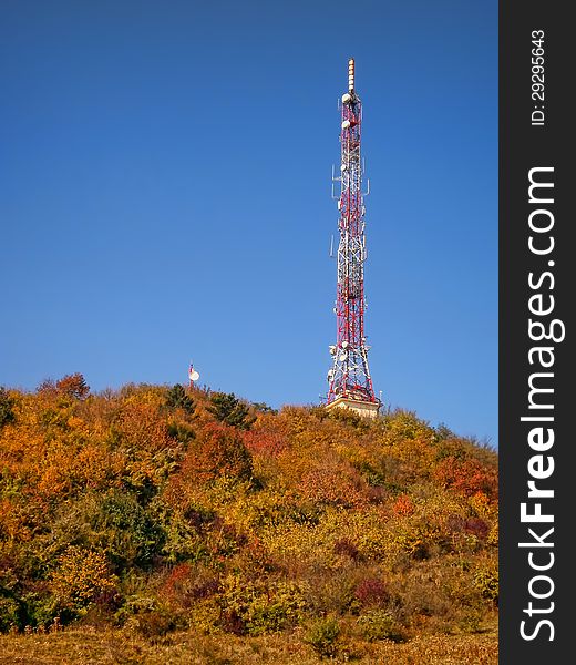 TV Transmission tower in autumn forest. TV Transmission tower in autumn forest