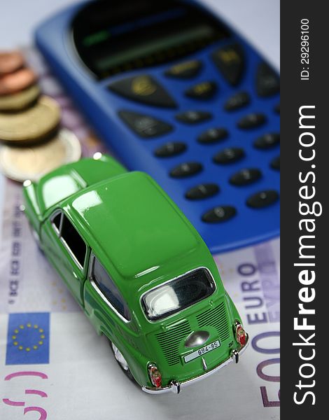 Small car, calculator and money as interesting economic background