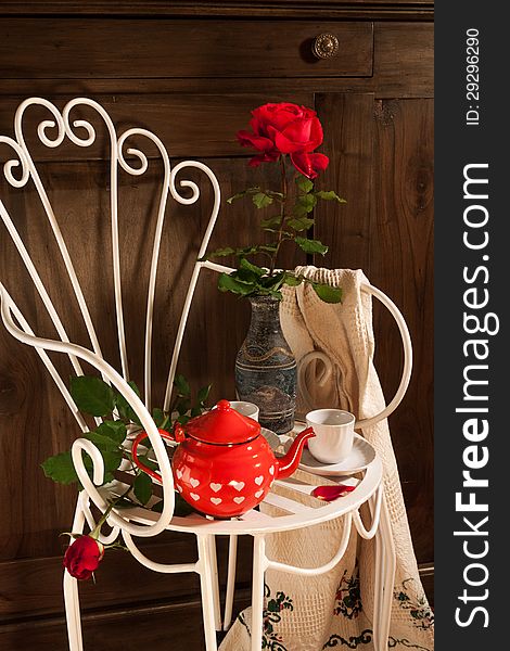 Still life with antique chair, flowers and tea