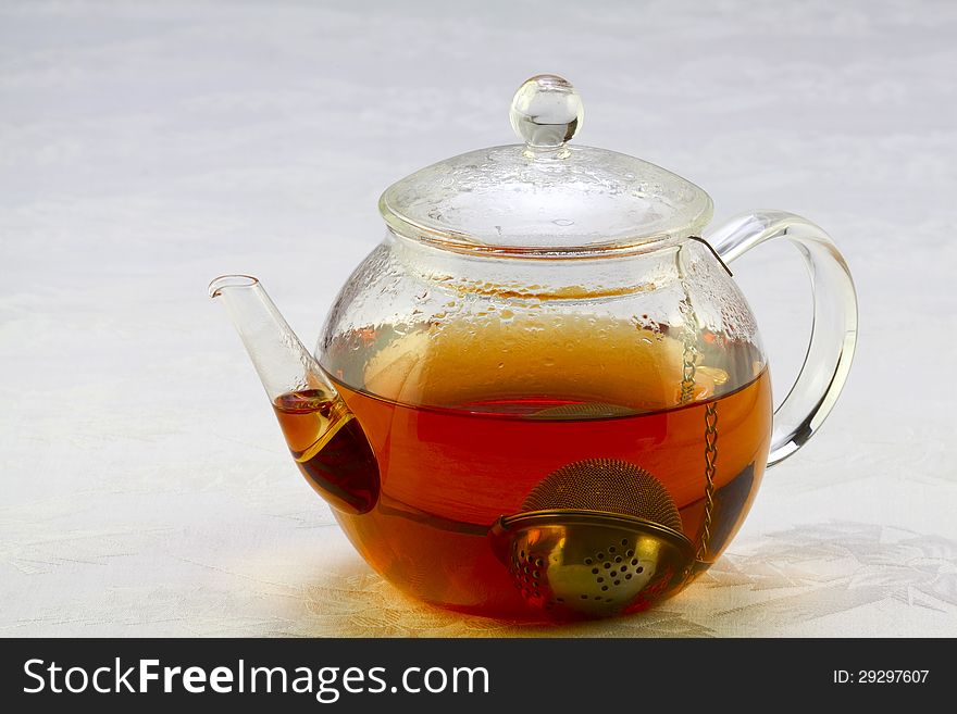 Teapot with tea and tea strainer. Teapot with tea and tea strainer