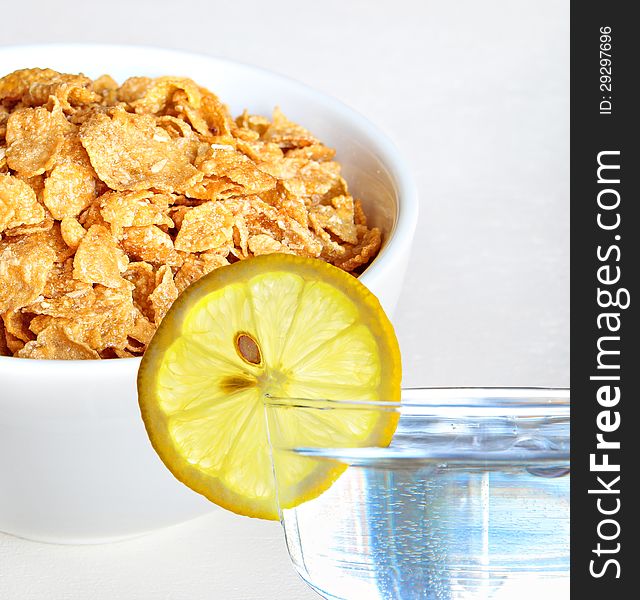 Photo showing bowl of healthy cereal and glass of water with slice of lemon!. Photo showing bowl of healthy cereal and glass of water with slice of lemon!