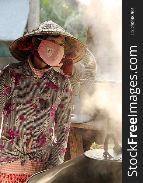 Vietnamese woman cooking food, Vietnam.