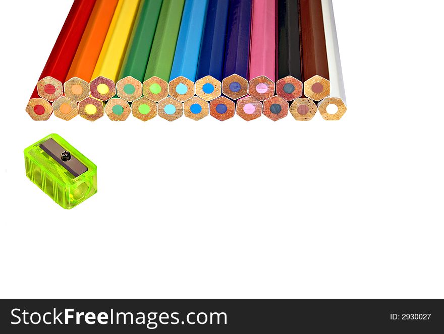 Unsharpened colored pencils with sharpener waiting
