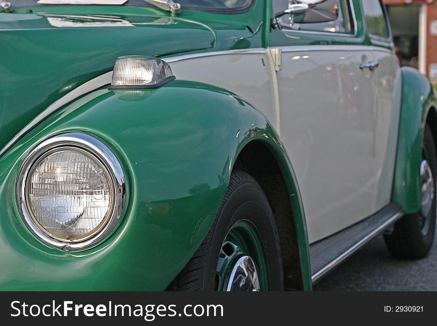 An old classic car painted green and grey. An old classic car painted green and grey