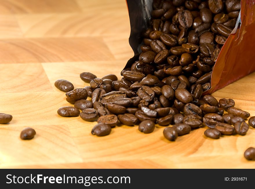 Whole coffee beans on wooden cutting board