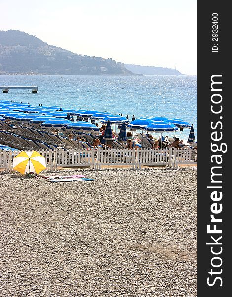 Beach With Blue Umbrellas