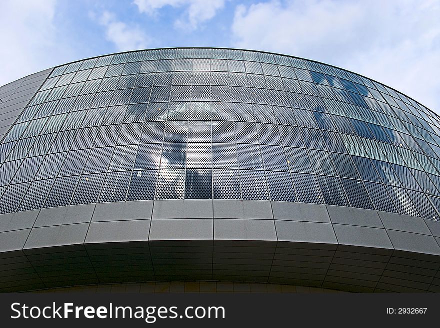 Glass front of shopping mall with reflection  of sky. Glass front of shopping mall with reflection  of sky