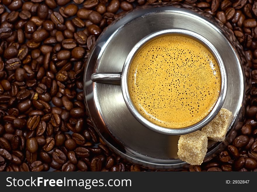 Cup of coffee in a pile of coffee beans