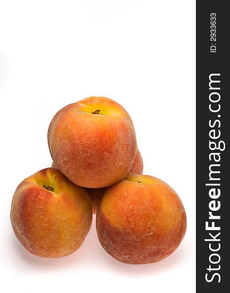 A stack of fresh peaches isolated on a white background. A stack of fresh peaches isolated on a white background