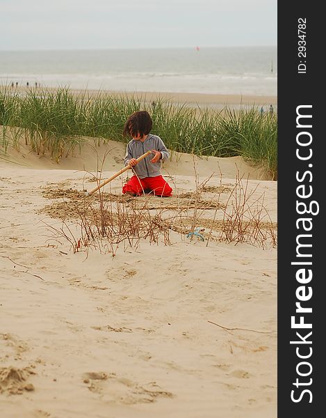 Small girl playing in dunes