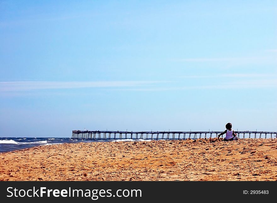 Photo of a alone kid on a beach. Photo of a alone kid on a beach.