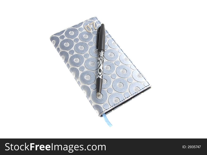 Photo of a notebook with pen