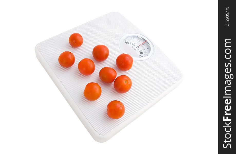 Photo of a tomatoes in a punnet on scales. Photo of a tomatoes in a punnet on scales
