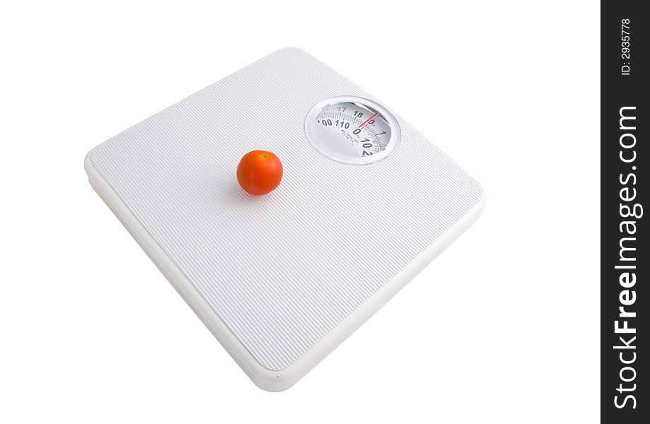 Photo of a tomatoes in a punnet on scales. Photo of a tomatoes in a punnet on scales