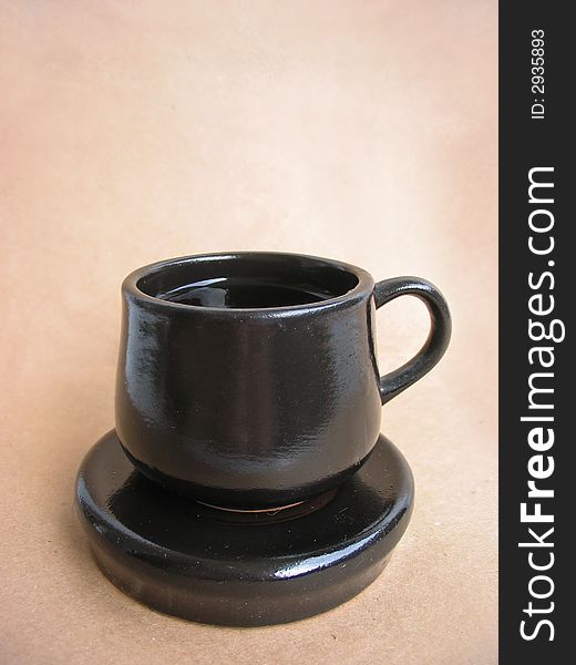 Cup And Saucer On Brown Backgr