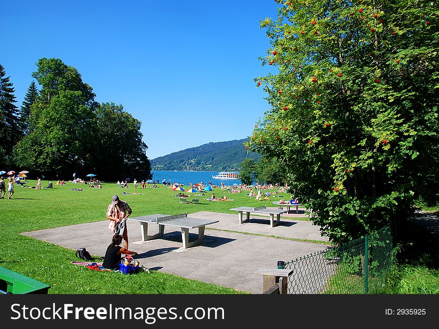 People by a beach of a sea. Tegernsee bavaria. People by a beach of a sea. Tegernsee bavaria