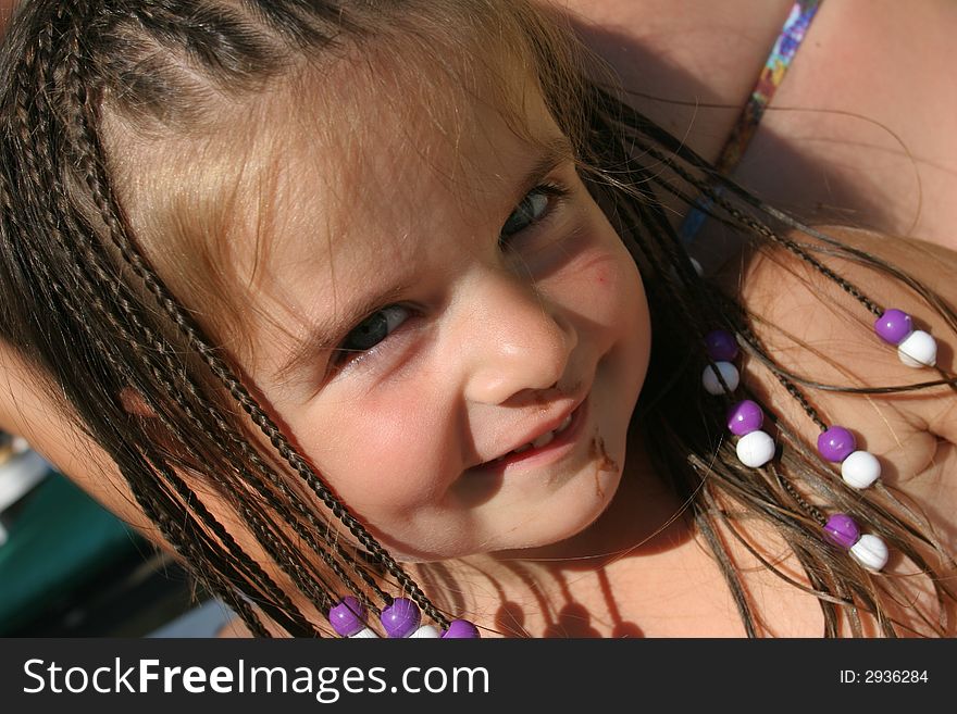 Little smiling girl with blue and white plait. Little smiling girl with blue and white plait