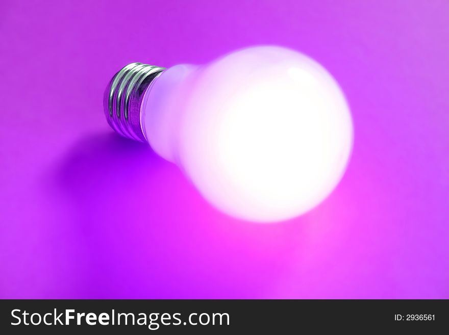 Light bulb isolated over a magenta background
