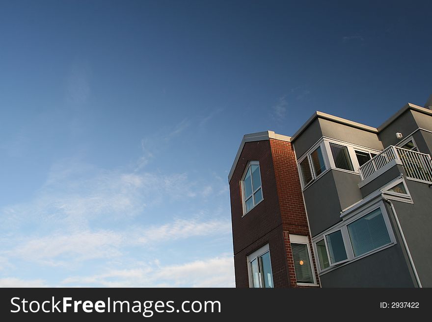 Condominiums set against vibrant blue sky. Condominiums set against vibrant blue sky.