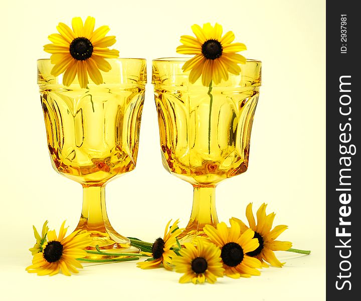 Black-eyed susans flowers and drinking glasses still life. Black-eyed susans flowers and drinking glasses still life