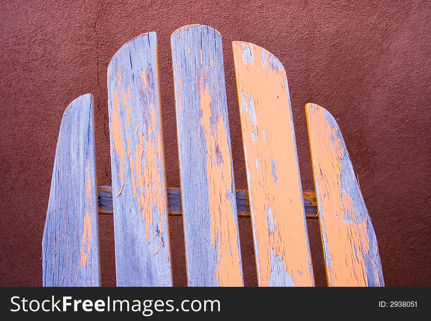 Top section of old wooden chair with peeling yellow paint. Top section of old wooden chair with peeling yellow paint