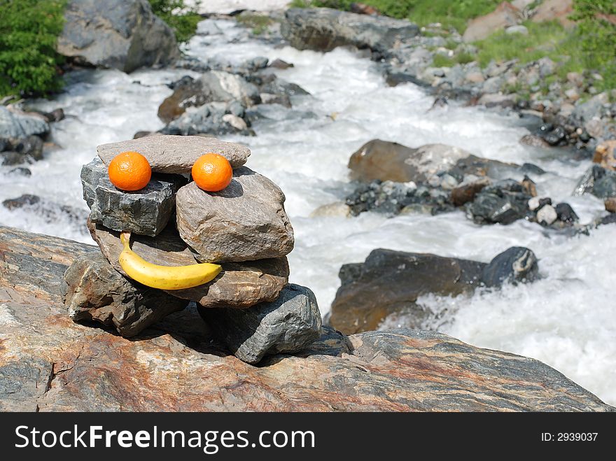 Smiling figure from fruits and stones. Smiling figure from fruits and stones