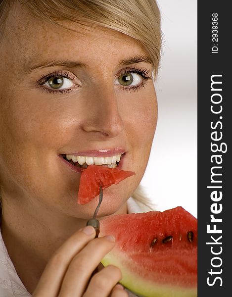 Young woman eating a watermelon close up