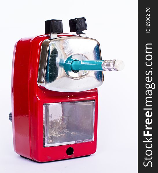 Red pencil sharpener with green pencil on white background