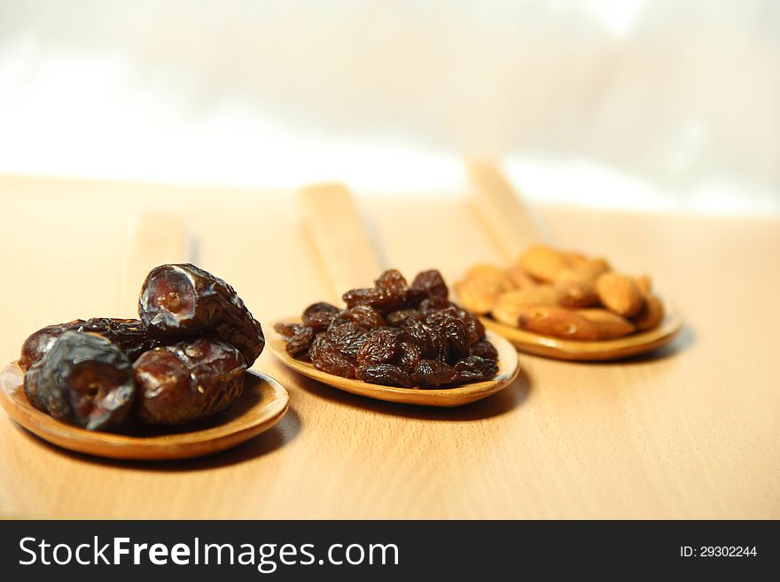 Delicious dry fruits on wooden spoon