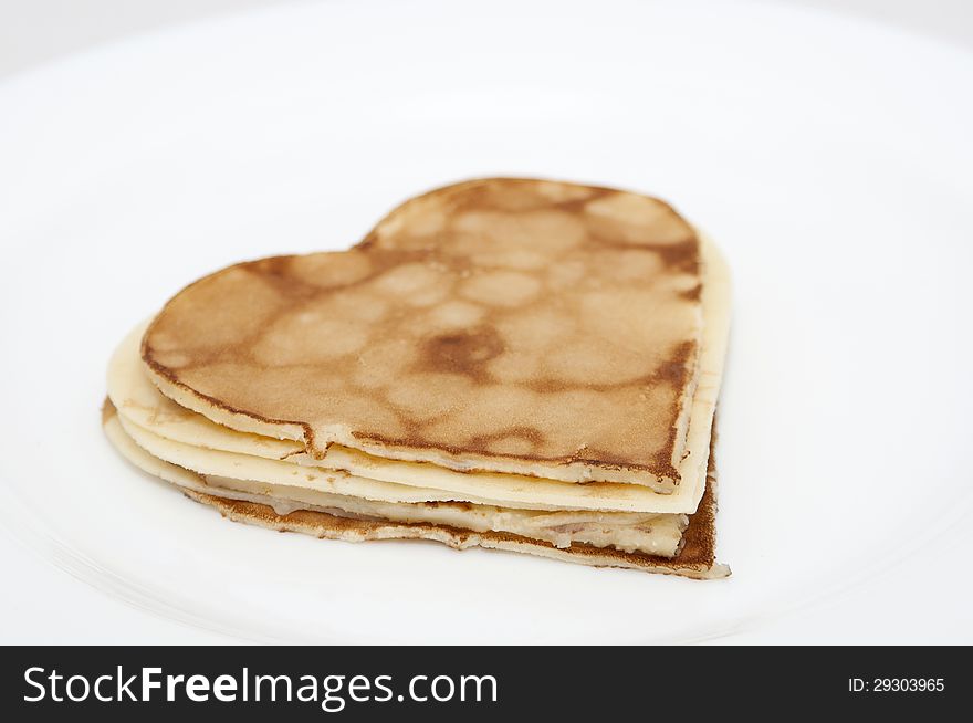 Heart-shaped Pancakes On White