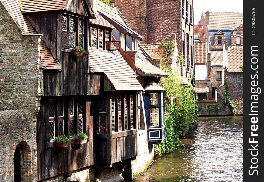 Channels, boat and houses of Bruges.