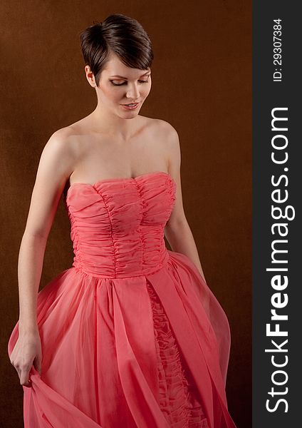 An image of a pretty woman wearing an elegant pink ball gown. An image of a pretty woman wearing an elegant pink ball gown