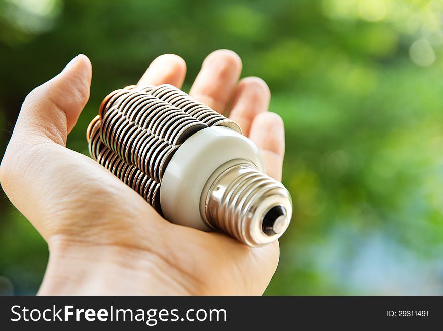 Hand holding coin light bulb,energy concept