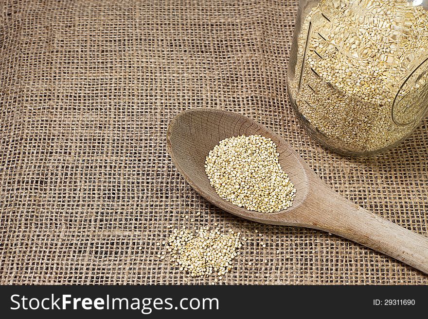 Quinoa And Wooden Spoon On Burlap Background-conce