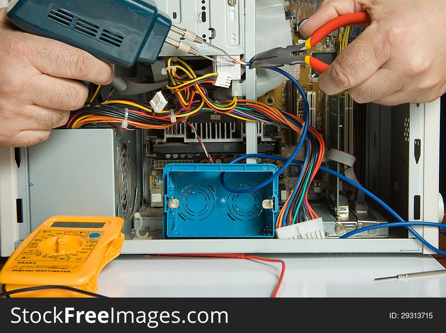 Electrician while working with cables and wires of electronic components