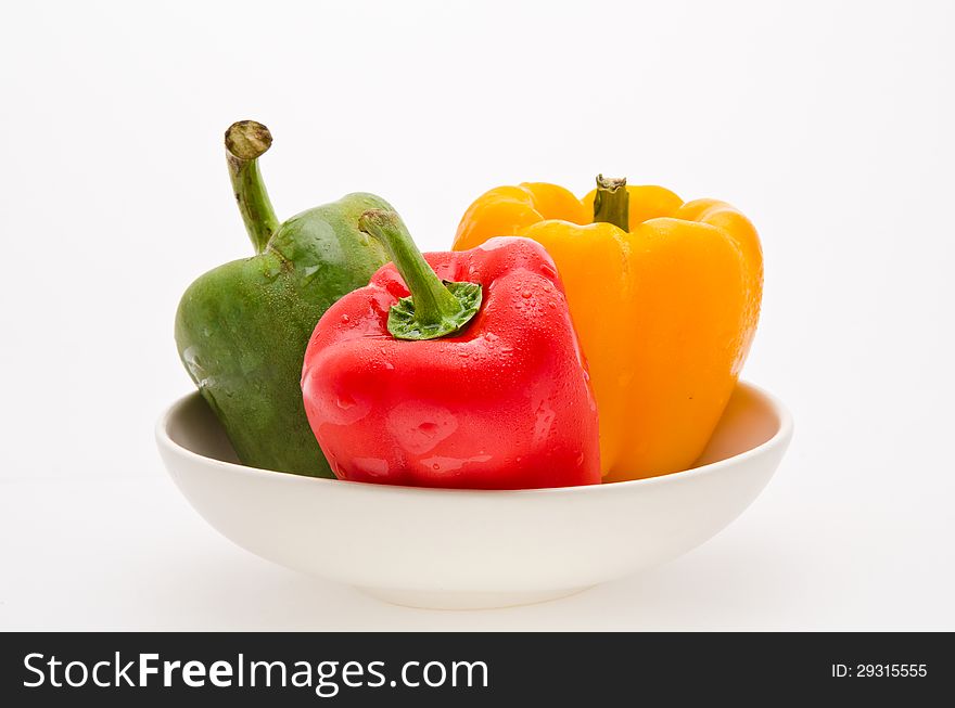 Red green yellow sweet peper on white bowl