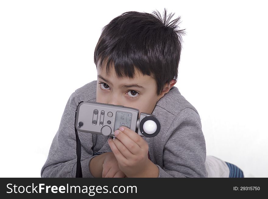 Portrait of a young child with a light meter to evaluate the light. Portrait of a young child with a light meter to evaluate the light.