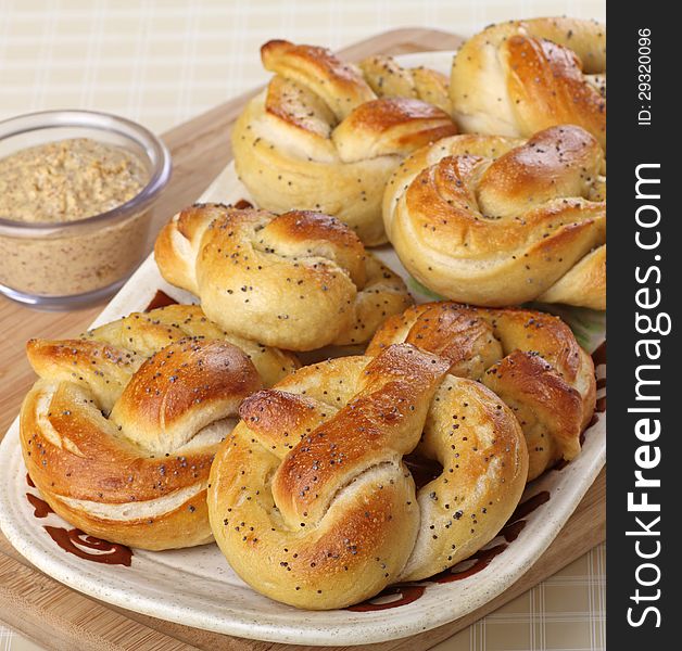 Soft pretzels on a platter with mustard dip