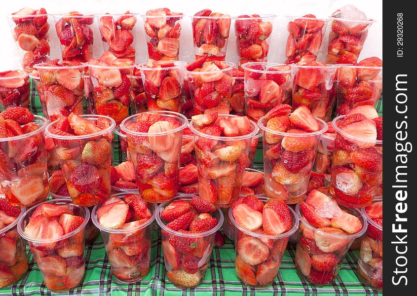 A half strawberry fruits in glass.