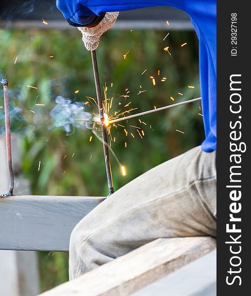 Welder welding elements at the construction site